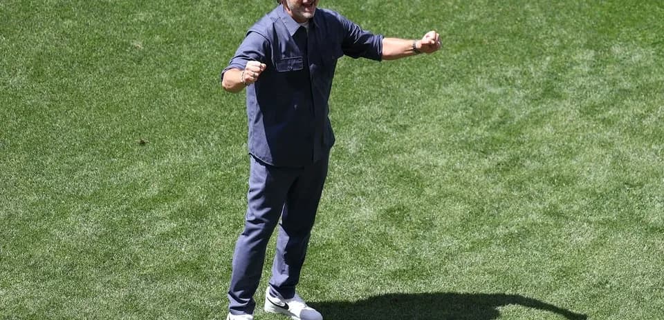 Coach celebrating on the pitch during training session