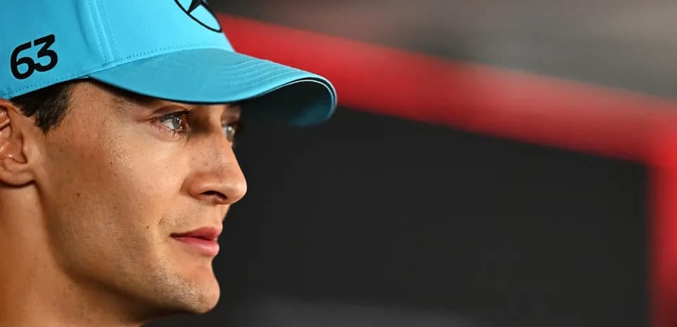 Driver wearing blue cap with Mercedes logo