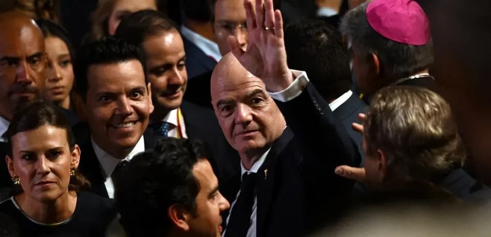 Man waving among a crowd at an event