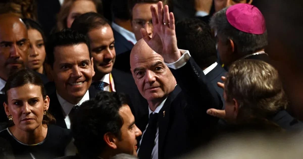 Man waving among a crowd at an event