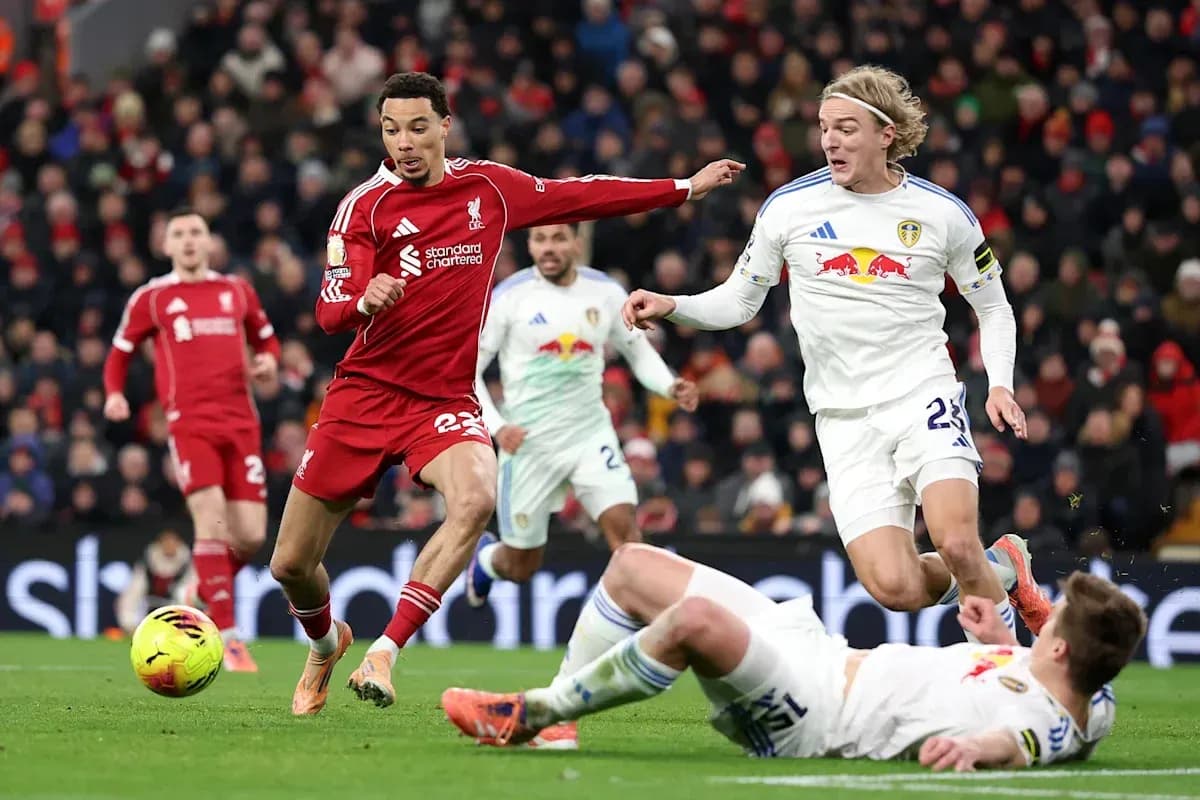 Liverpool player dribbling past Leeds United opponents Liverpool player dribbling past Leeds United opponents