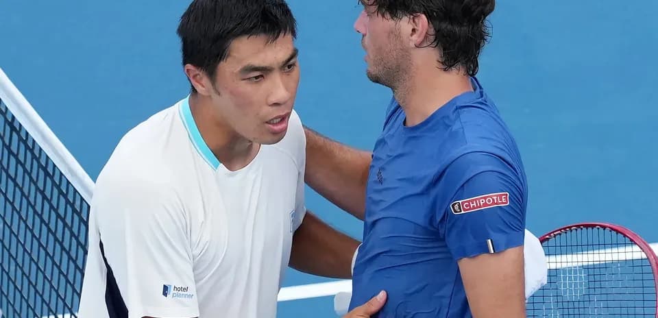 Tennis players shaking hands at the net
