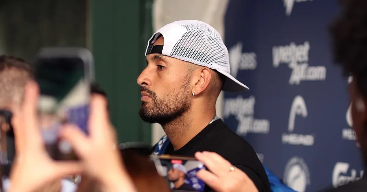 Athlete speaking at press conference surrounded by fans
