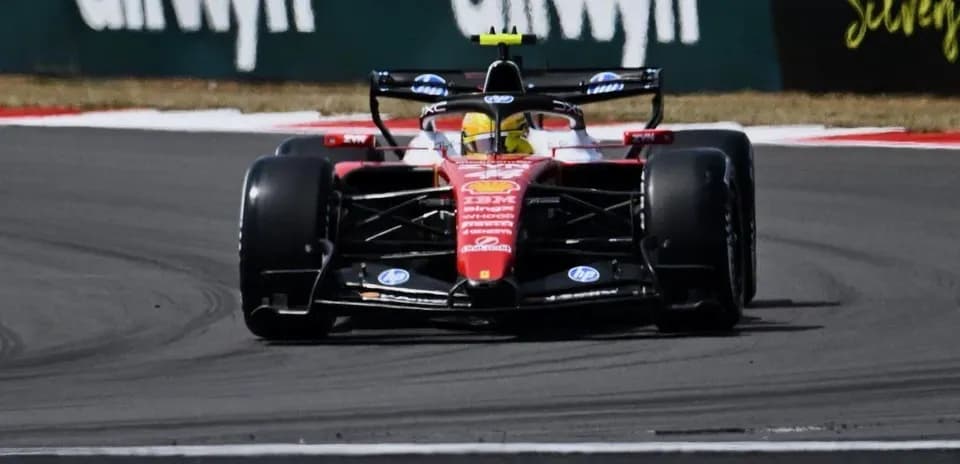 Formula 1 car navigating a turn on racetrack