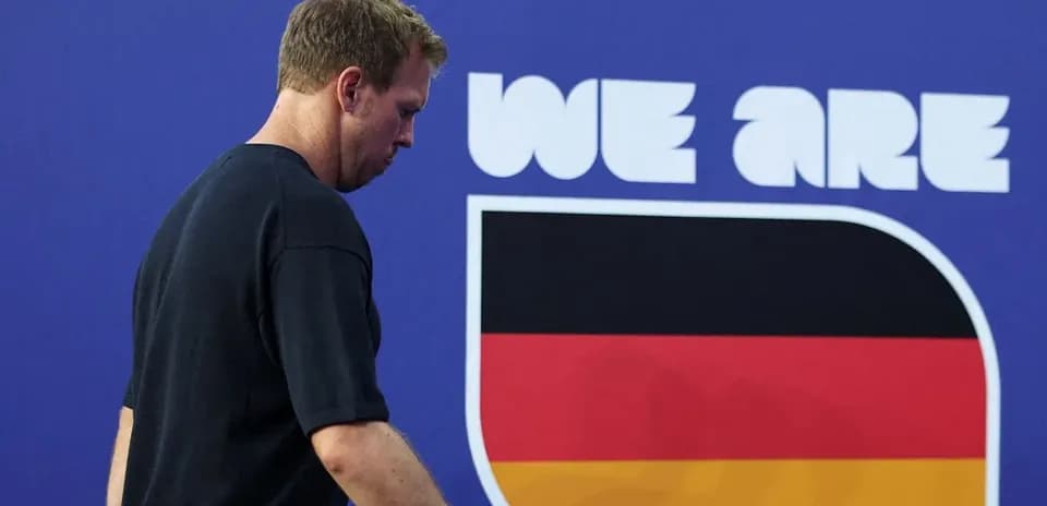 Athlete walking past 'We Are Germany' banner