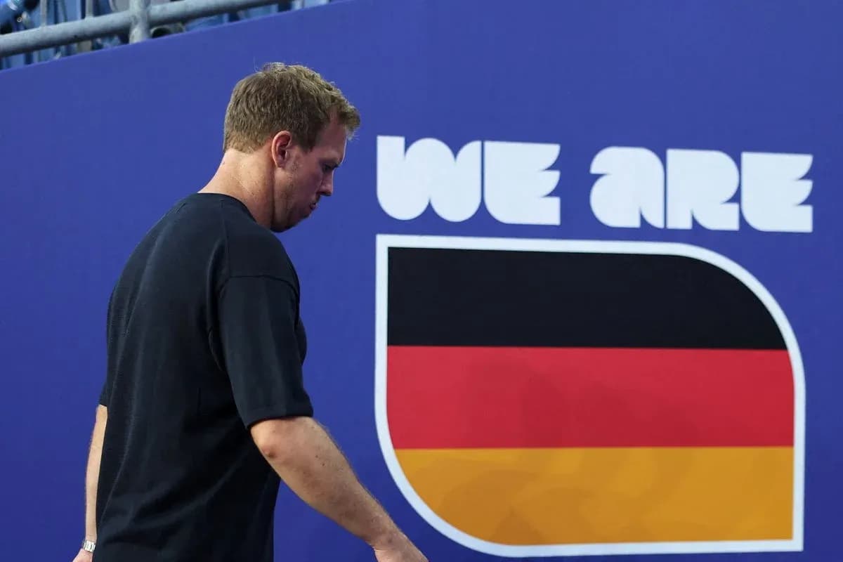 Athlete walking past 'We Are Germany' banner Athlete walking past 'We Are Germany' banner