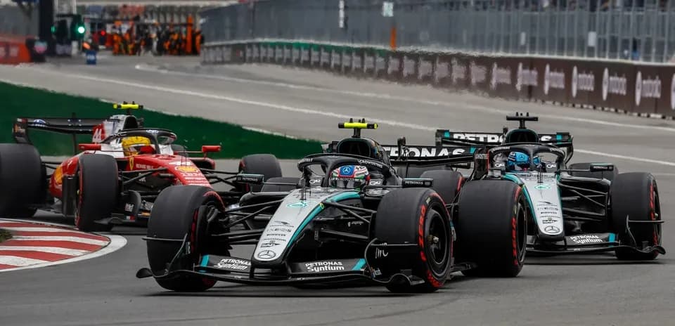 Formula 1 cars racing closely on track