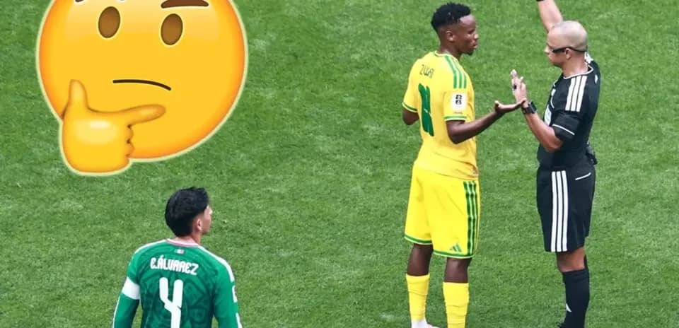 Player discussing with referee during football match