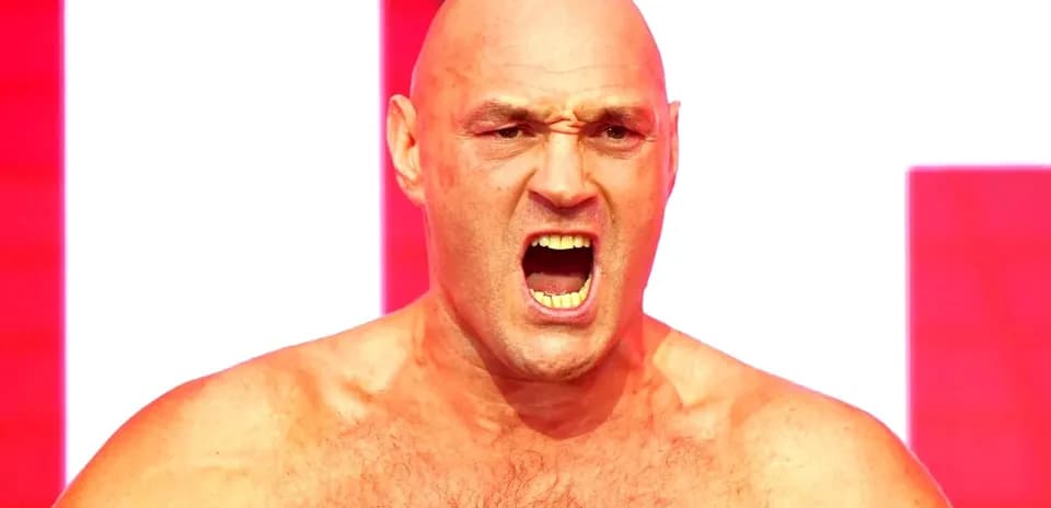 Bald man shouting with intense expression on stage