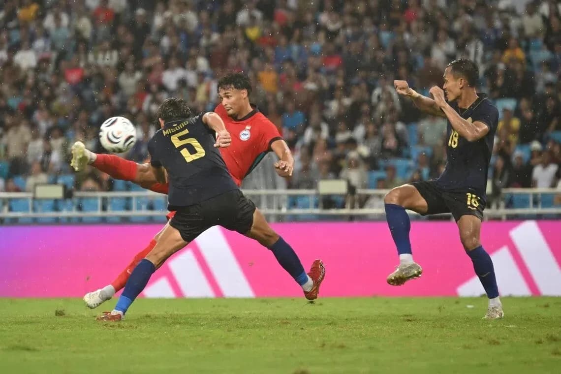 Player attempting to pass the ball during match Player attempting to pass the ball during match