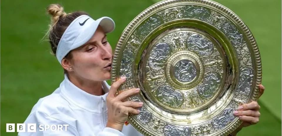 Tennis player kissing trophy after winning match