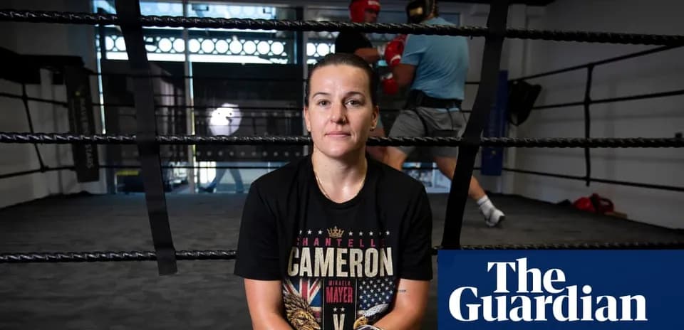 Boxer seated in ring with training session behind