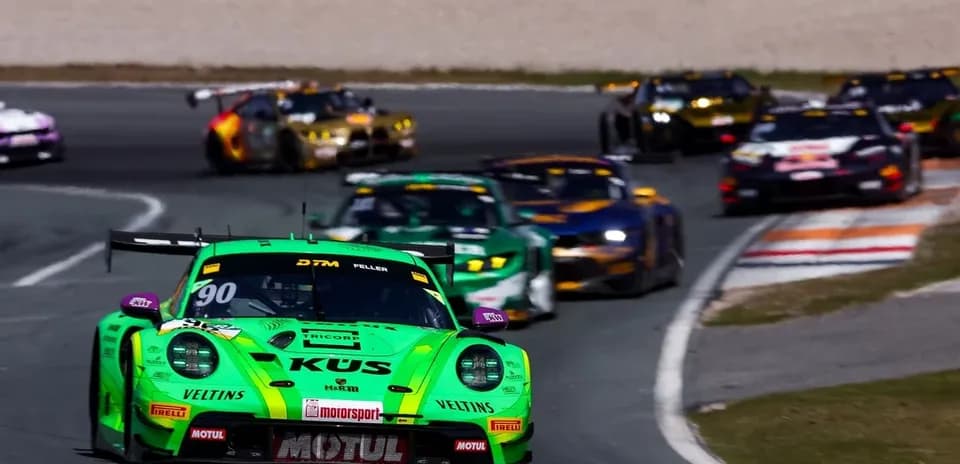Green racing car leading in a DTM race