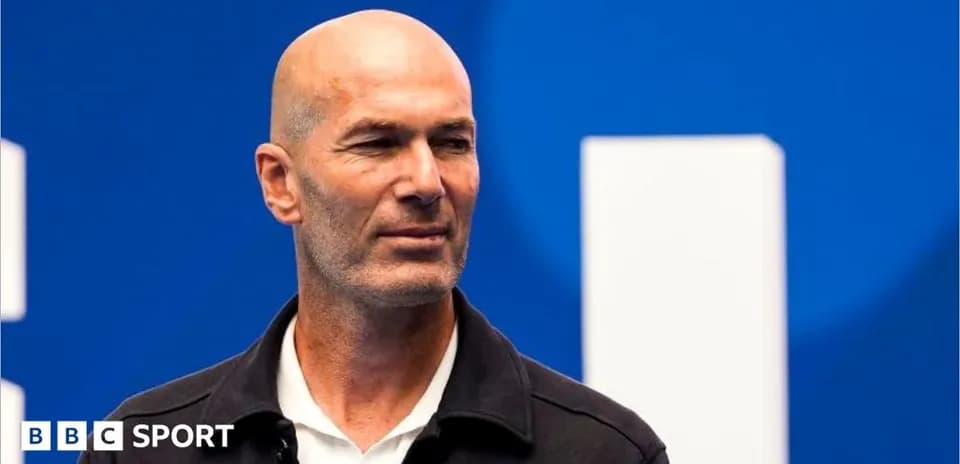 Zinedine Zidane at a press event with blue background