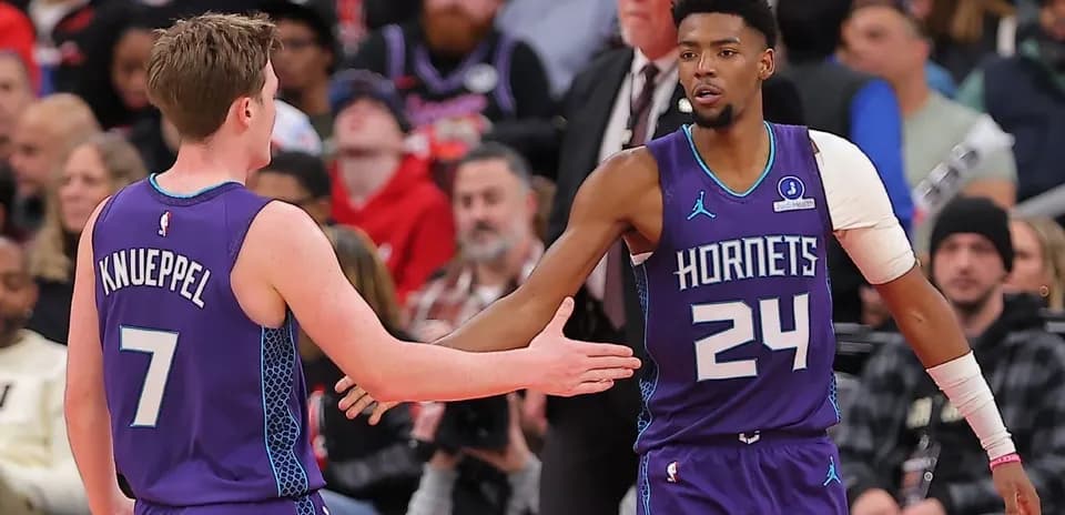 Two Charlotte Hornets players exchanging high-fives