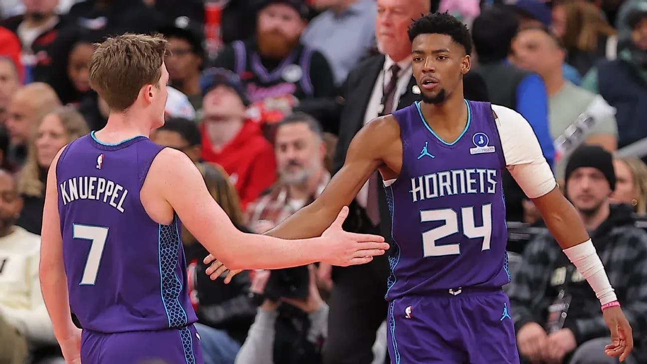 Two Charlotte Hornets players exchanging high-fives