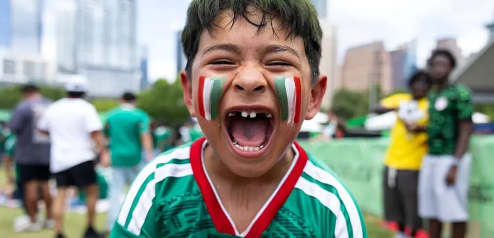 Boys cheering with painted faces at event