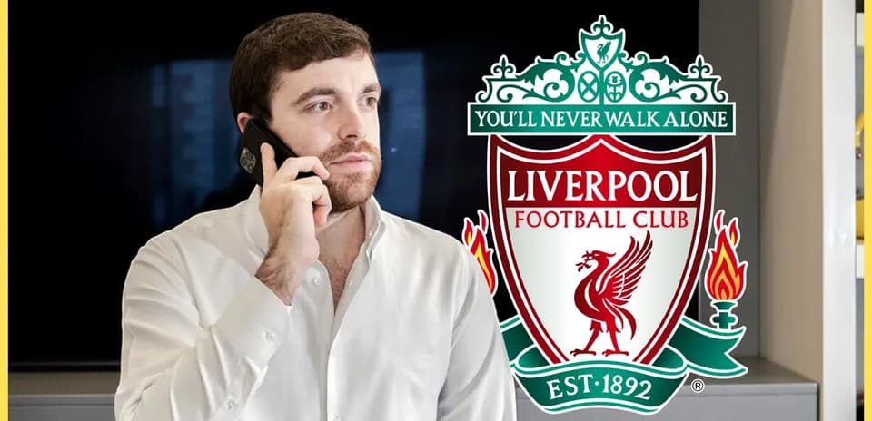 Man talking on phone with Liverpool FC logo