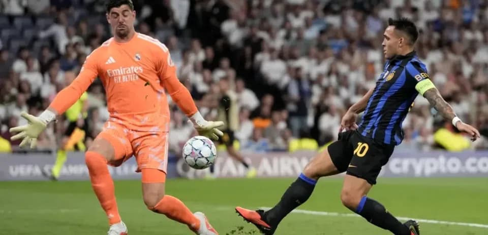 Goalkeeper blocking shot from opposing player during match