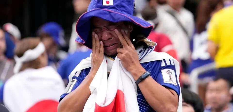 Japan fan in tears wearing national colors at event