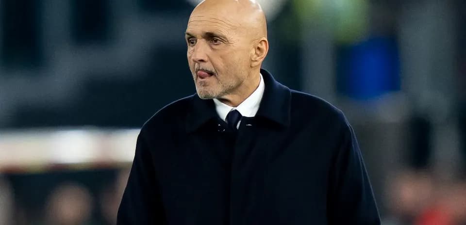 Bald coach walking on the sideline during match