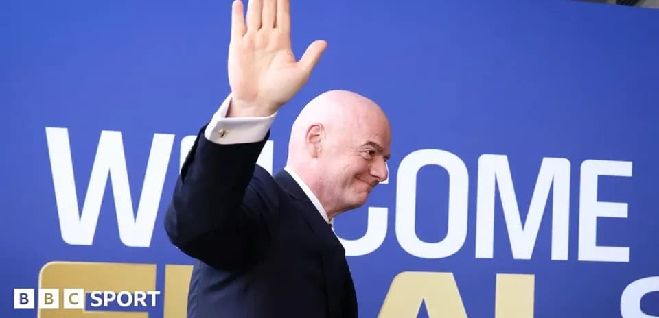 FIFA president waving at event backdrop
