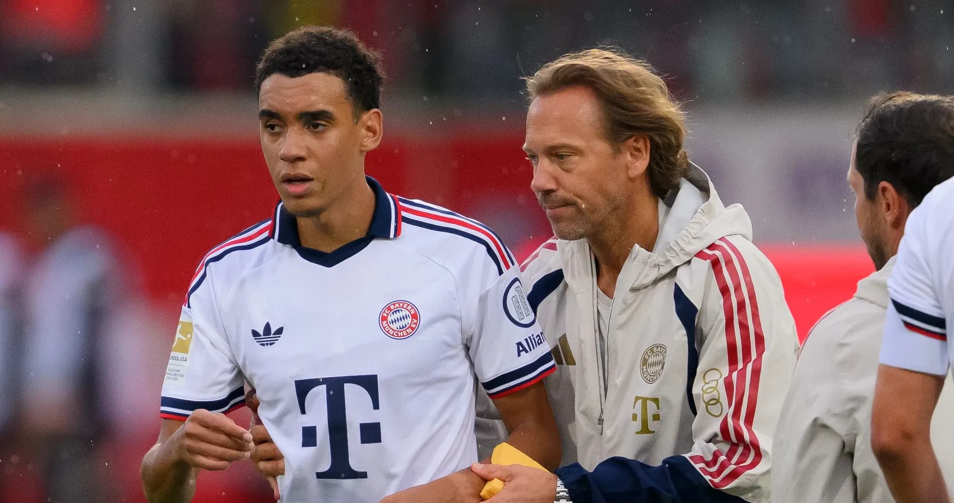 Bayern Munich player receiving instructions from coach