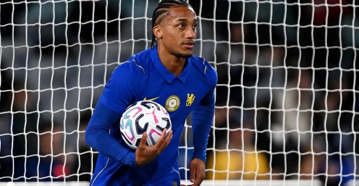 Goalkeeper in blue jersey holding football near goal Goalkeeper in blue jersey holding football near goal