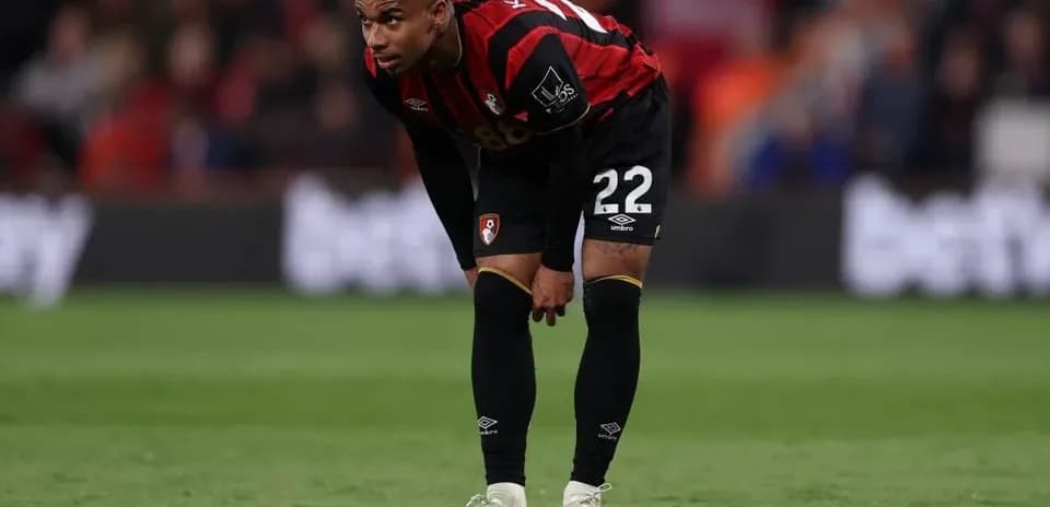 AFC Bournemouth player bending down on the pitch
