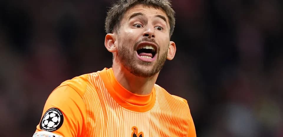 Goalkeeper shouting during a match in orange kit