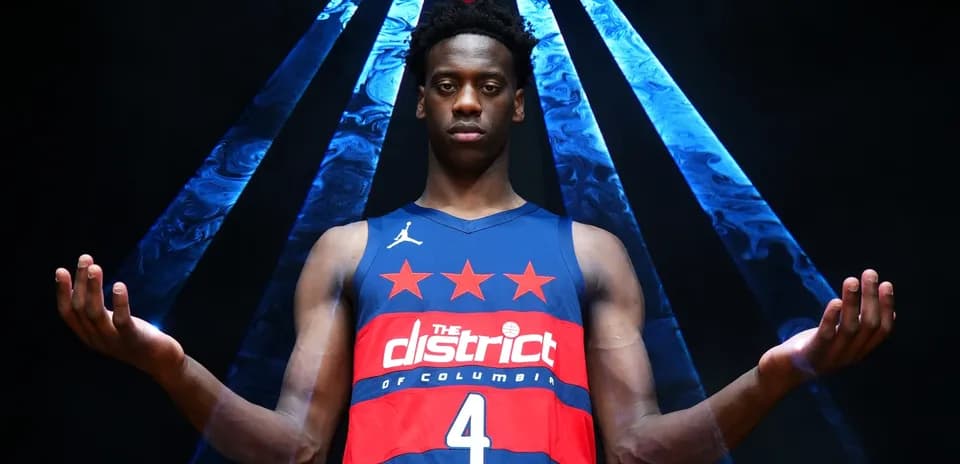 Basketball player in jersey posing with arms outstretched