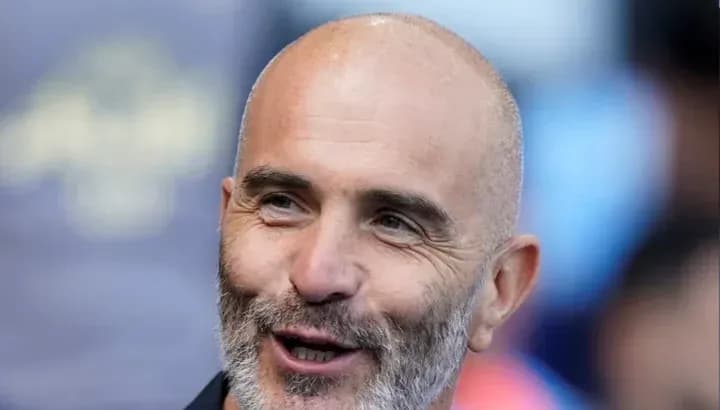 Bald man with beard smiling at the camera