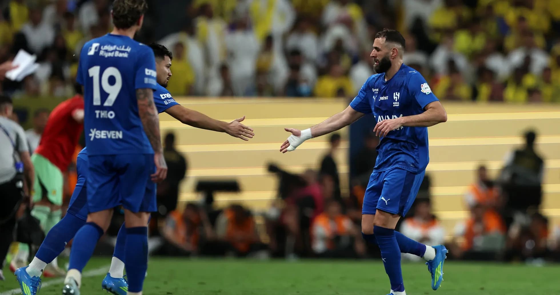 Football players exchanging handshakes on the pitch