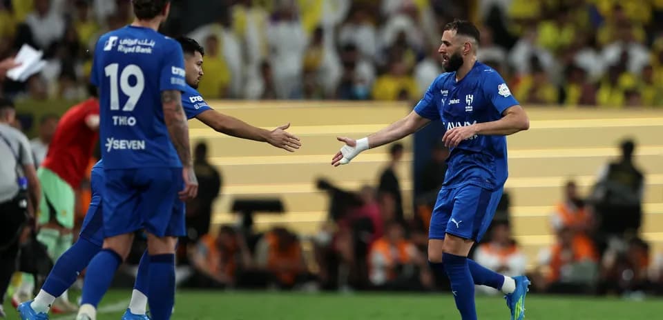 Football players exchanging handshakes on the pitch