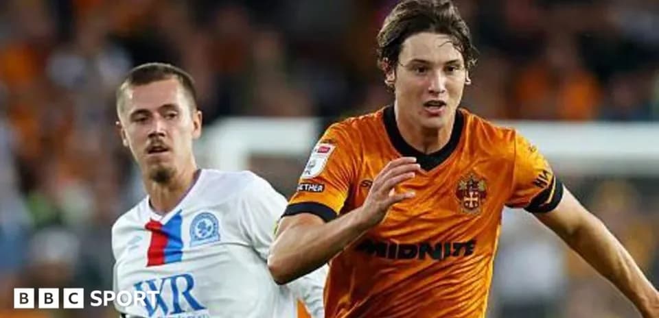 O'yinchi to'pni quvlayotgan futbol o'yinida