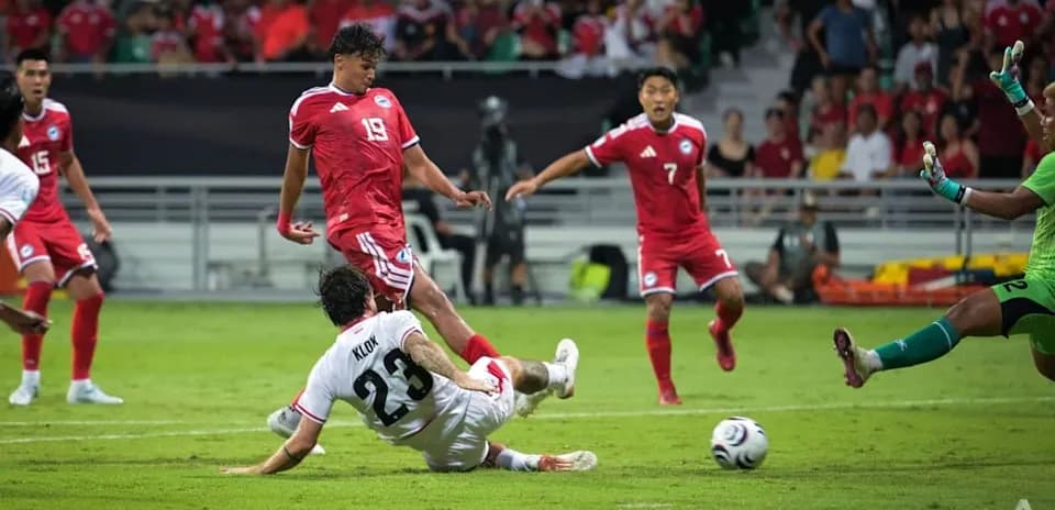 Player tackling opponent during football match action