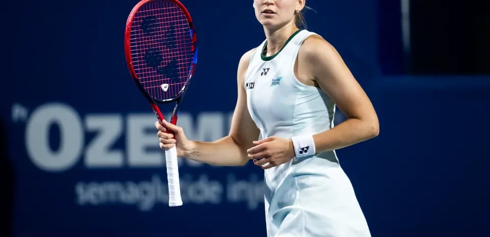 Tennis player preparing to serve on court