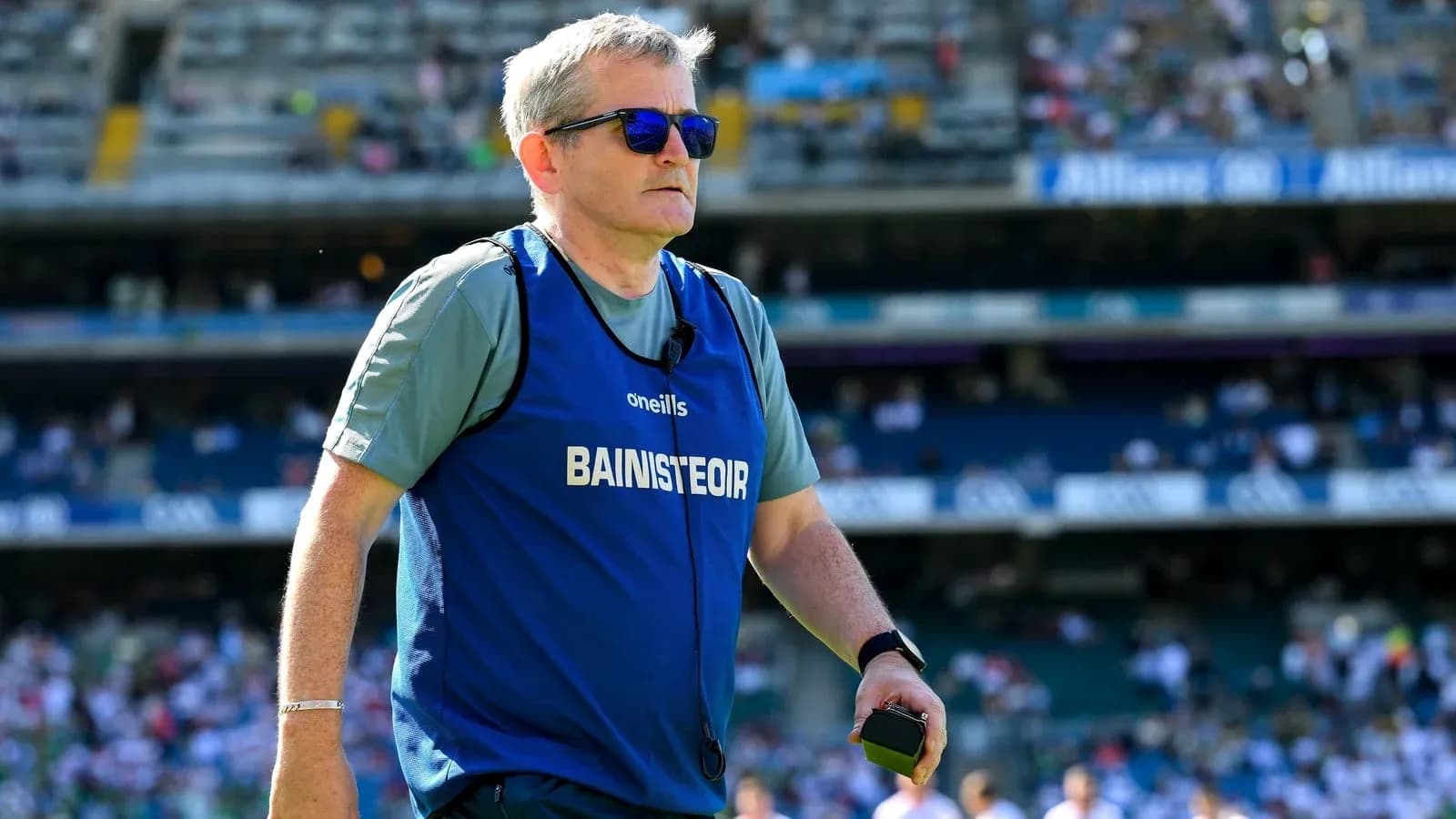 Coach wearing sunglasses on the pitch during match