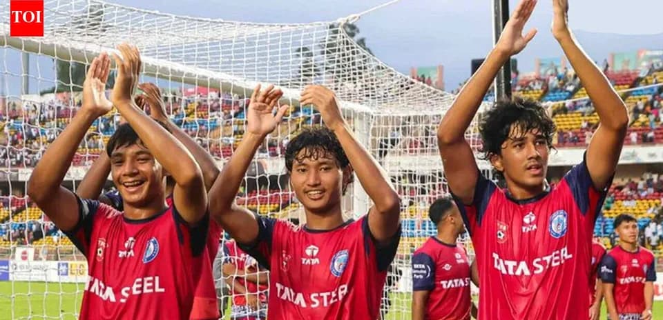 Three players celebrating after a football match
