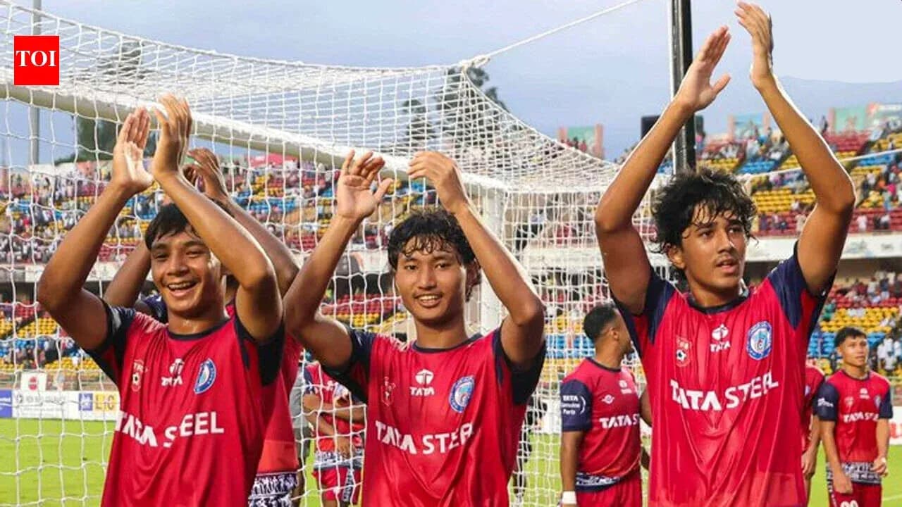 Three players celebrating after a football match