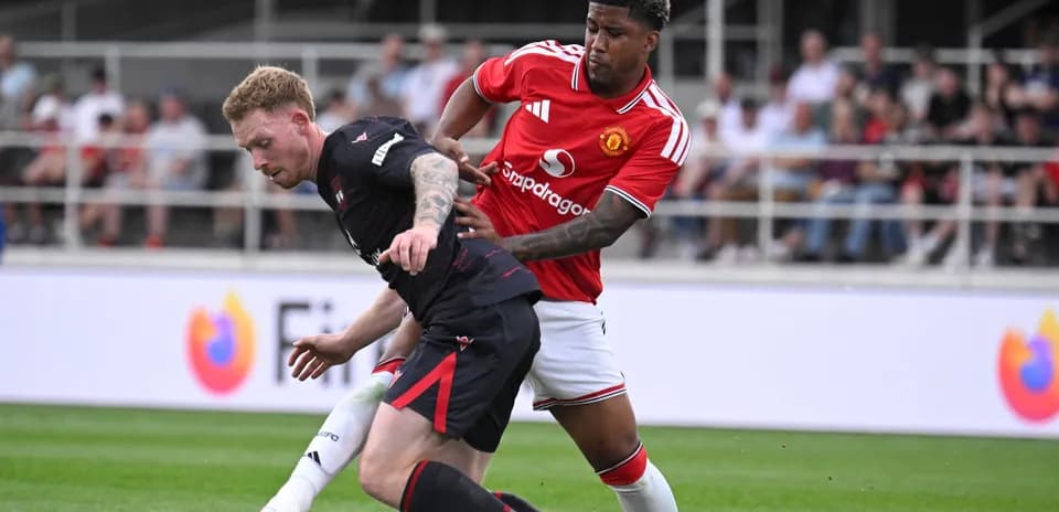 Player tackling opponent during football match