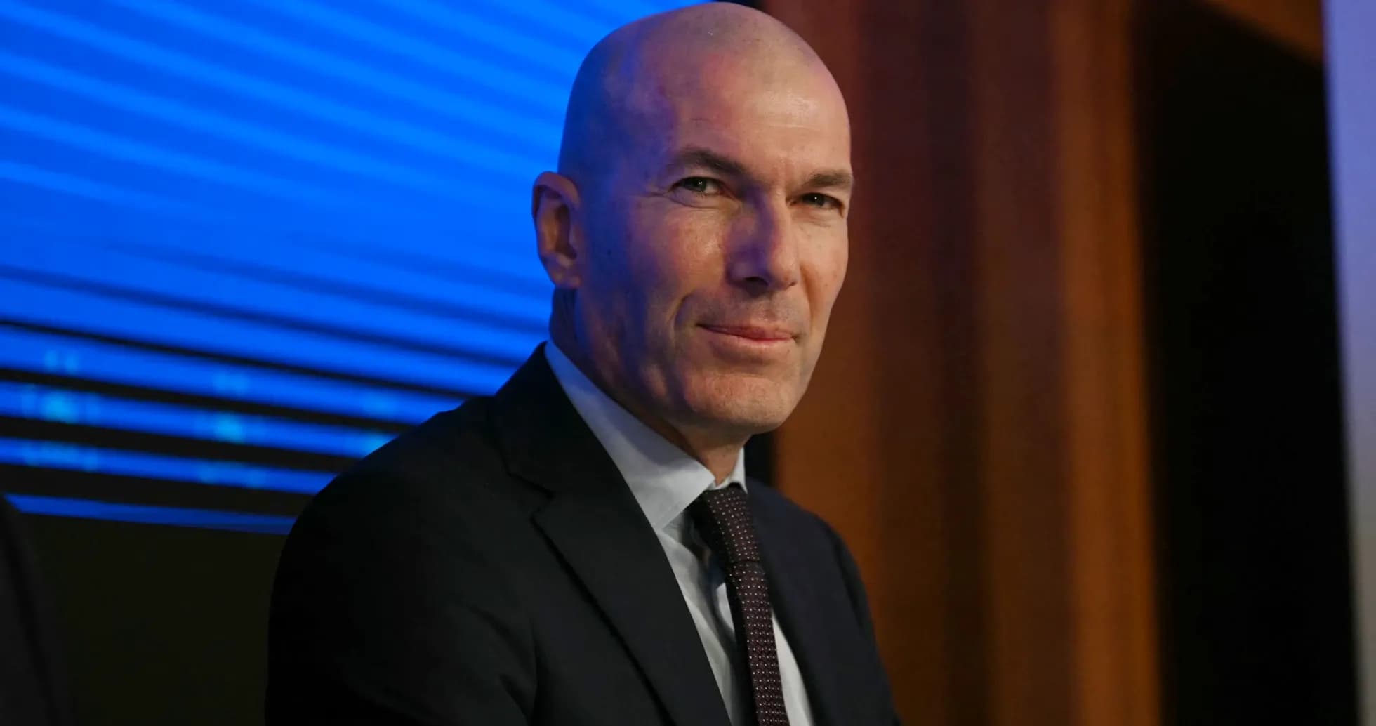 Bald man in suit at press conference