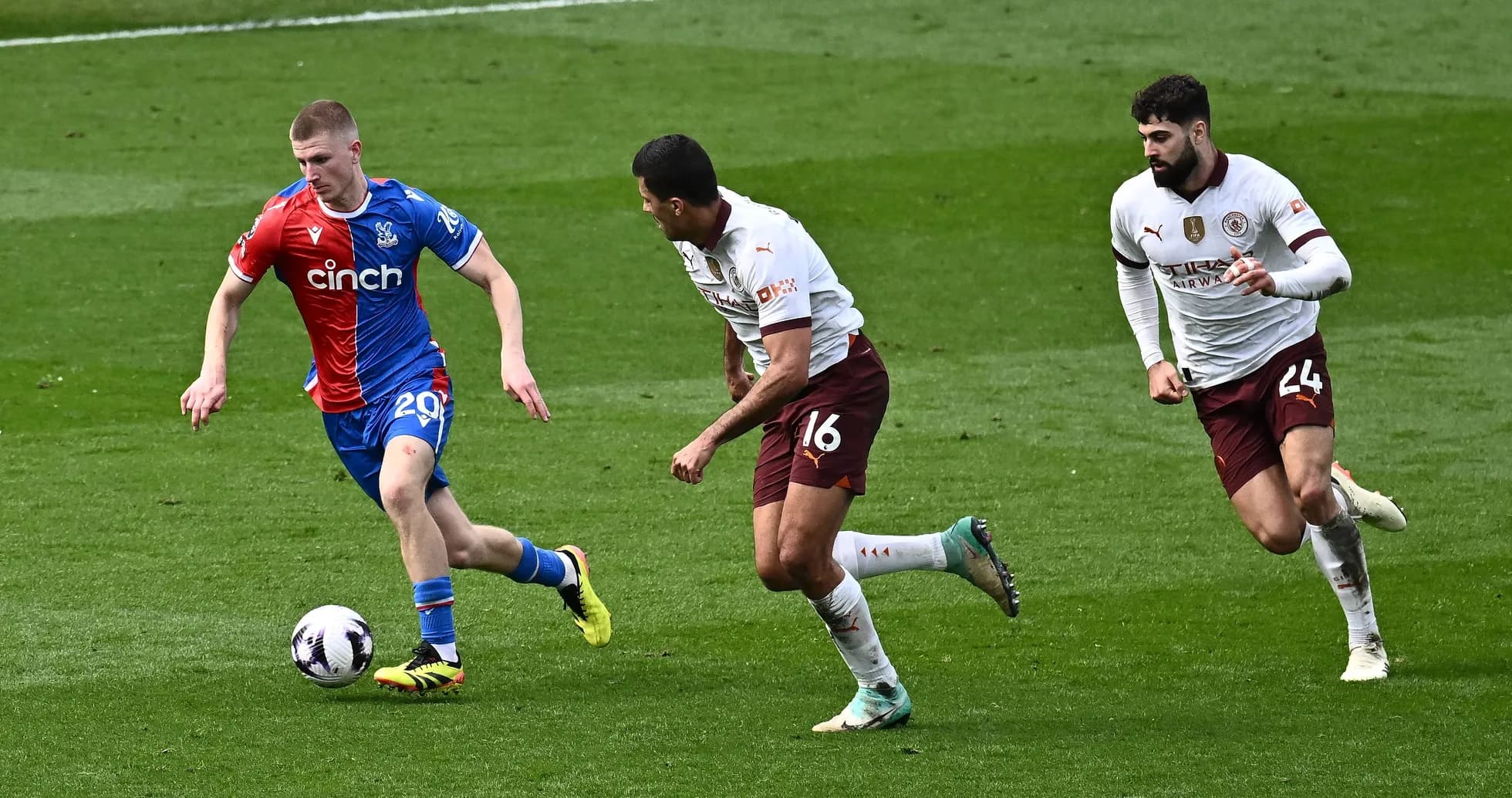Crystal Palace player dribbling past two defenders