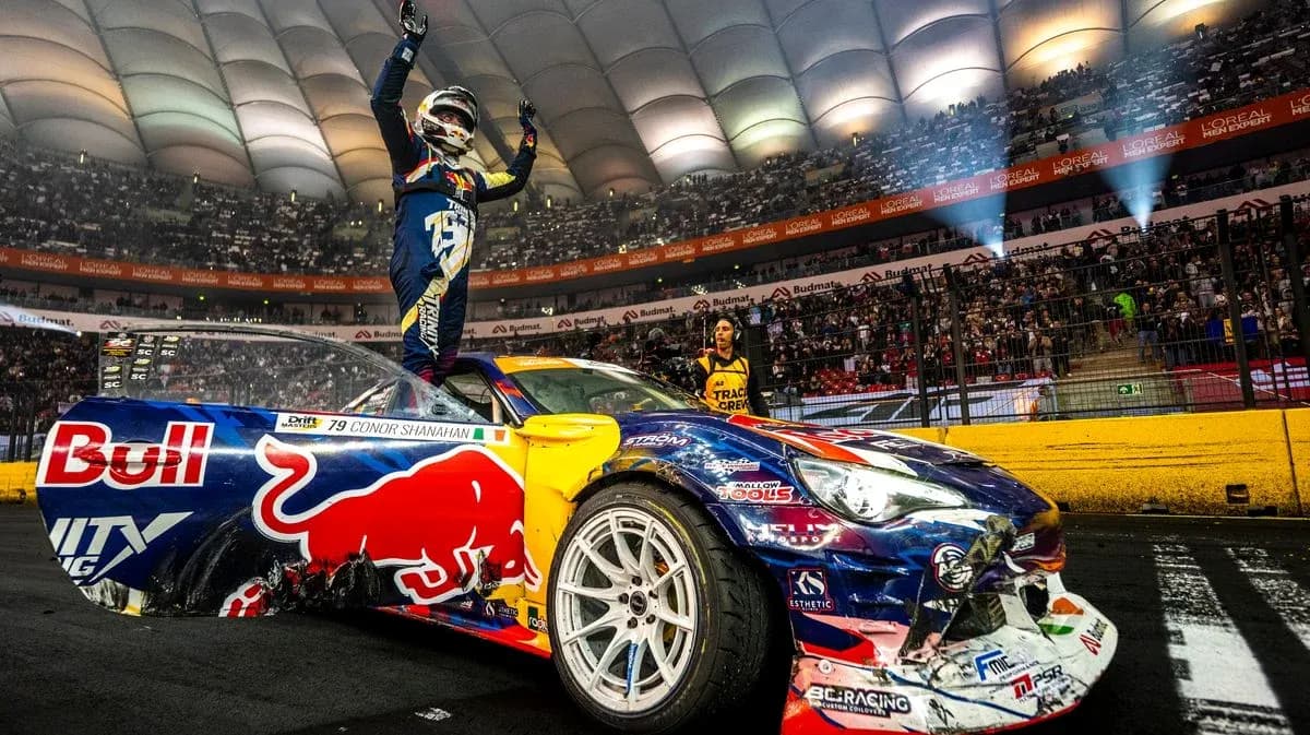 Drifter celebrating victory on car in arena