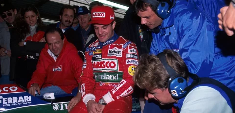 Pilot sitting in car with team members around