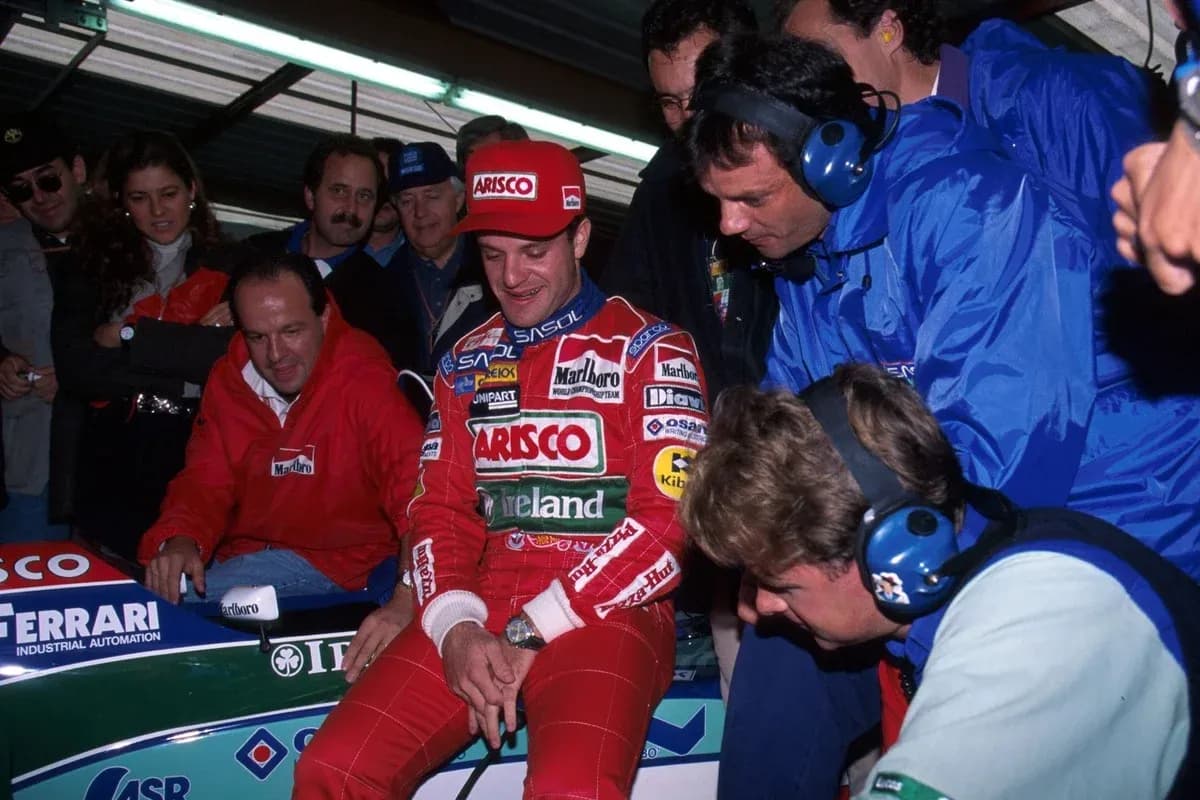 Pilot sitting in car with team members around