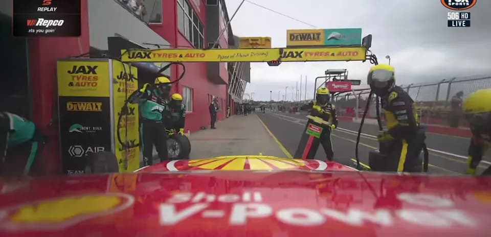 Pit stop during a car race with team members