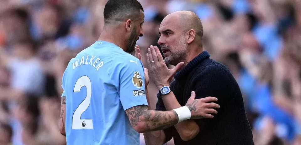 Walker discussing strategy with Guardiola on pitch