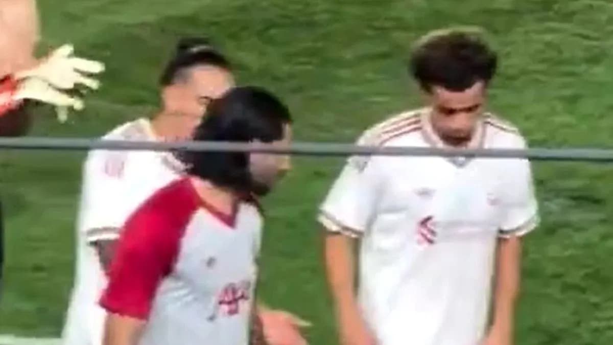 Football players on the sidelines during match