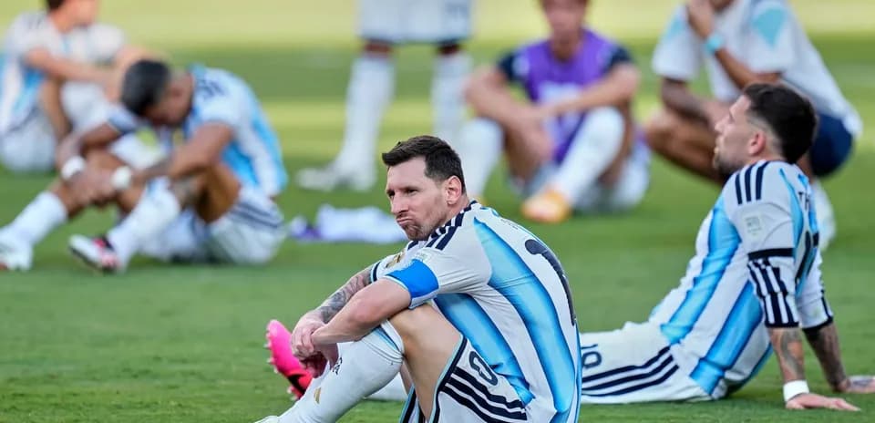 Argentina players sitting on field after match